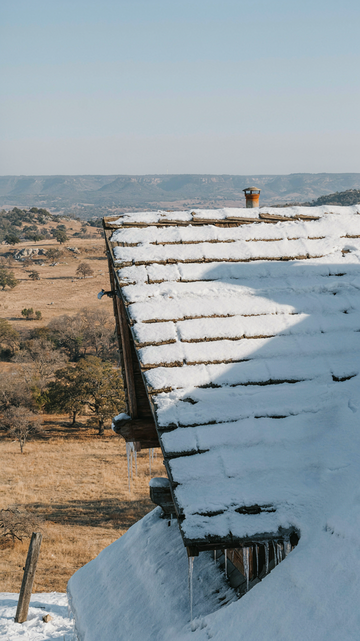 A snow-covered mountain roof juxtaposed with a dry Texas landscape.