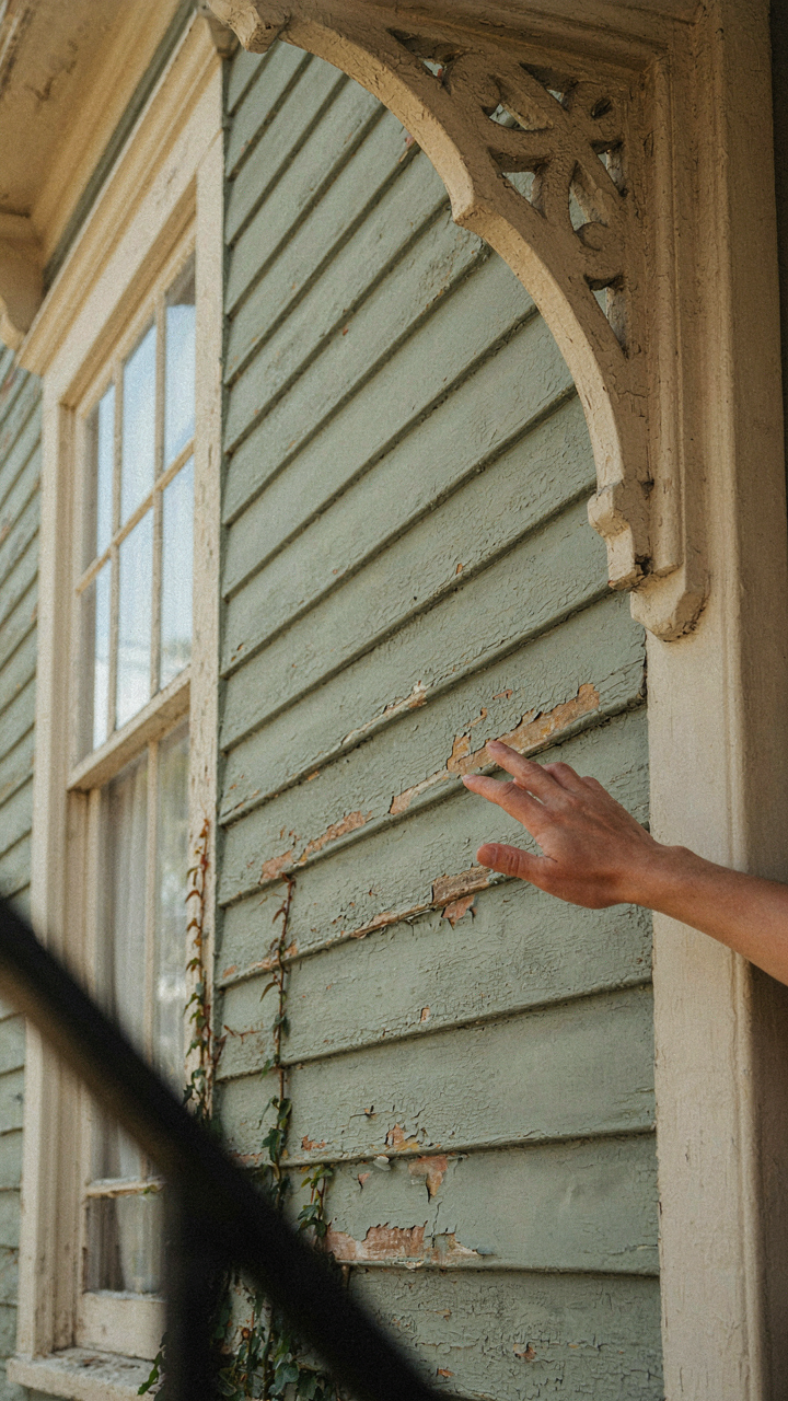 Close up of Victorian house siding with multiple paint layers, showing practical protection.
