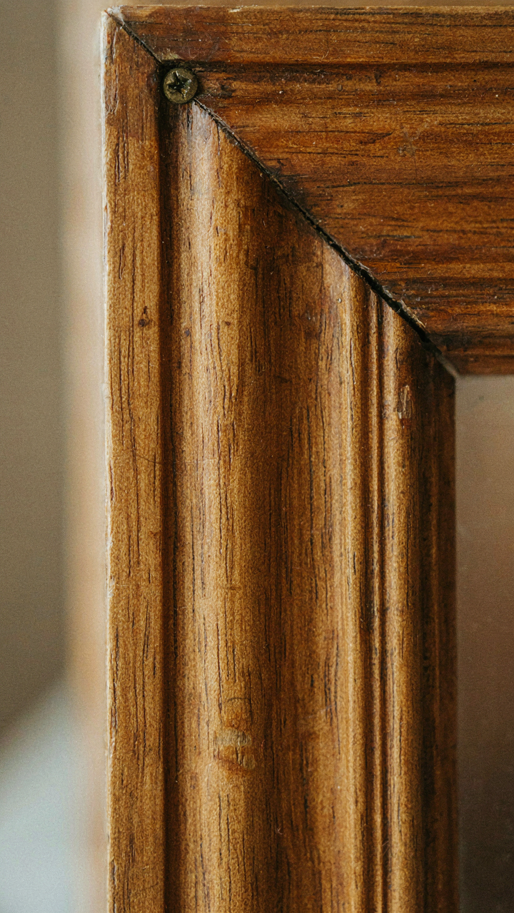 A close-up of aged and weathered craftsman wooden trim with natural patina.