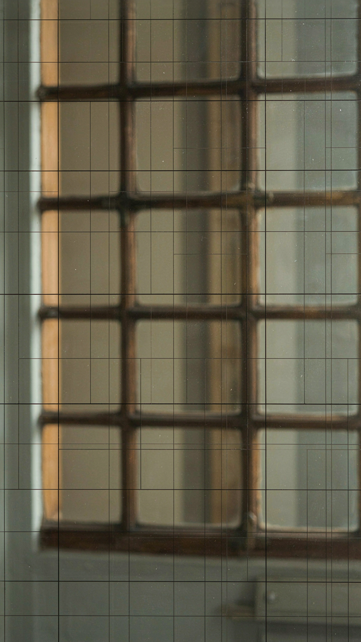 A modern window with a decorative grid next to an antique window with structural prairie style