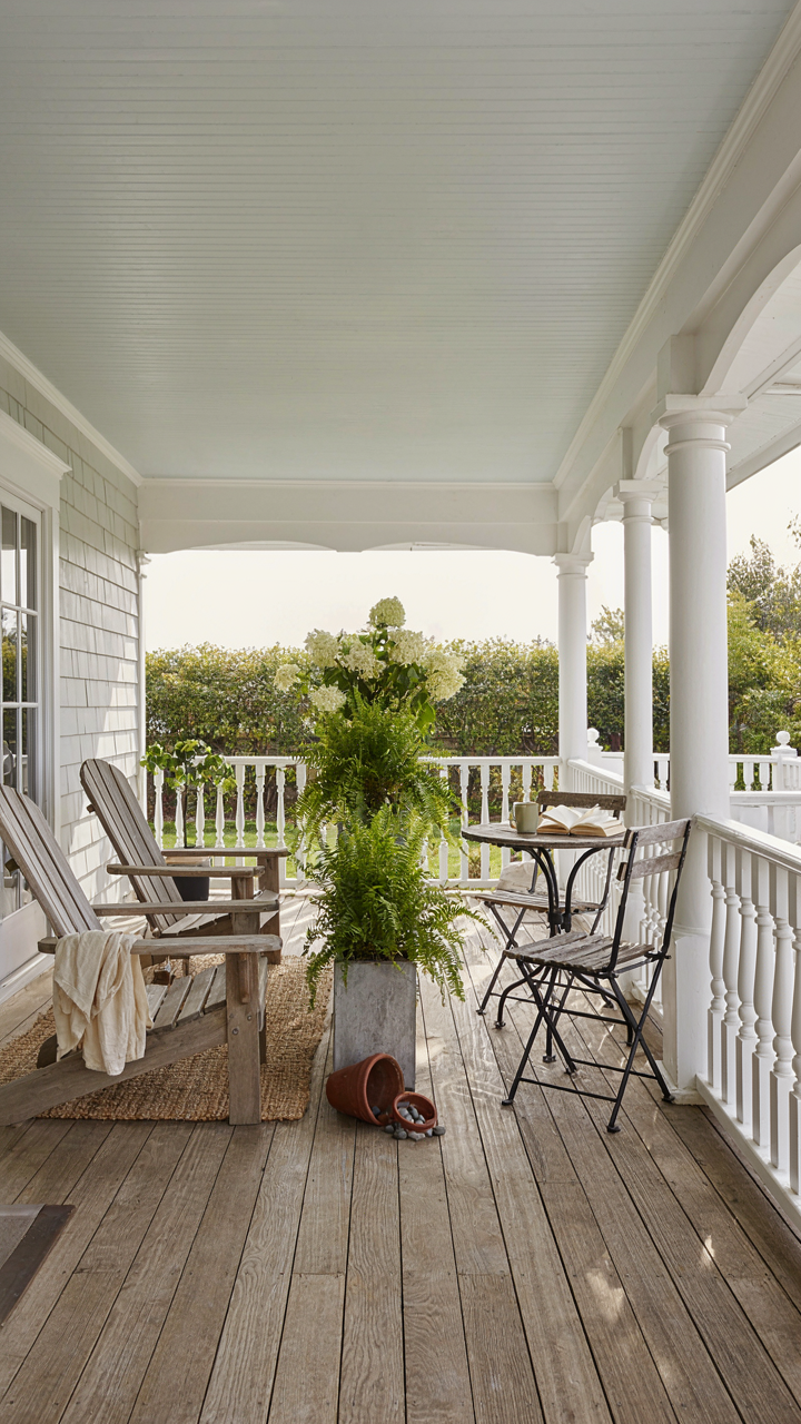 A wraparound porch zoned for different activities, with seating areas defined.