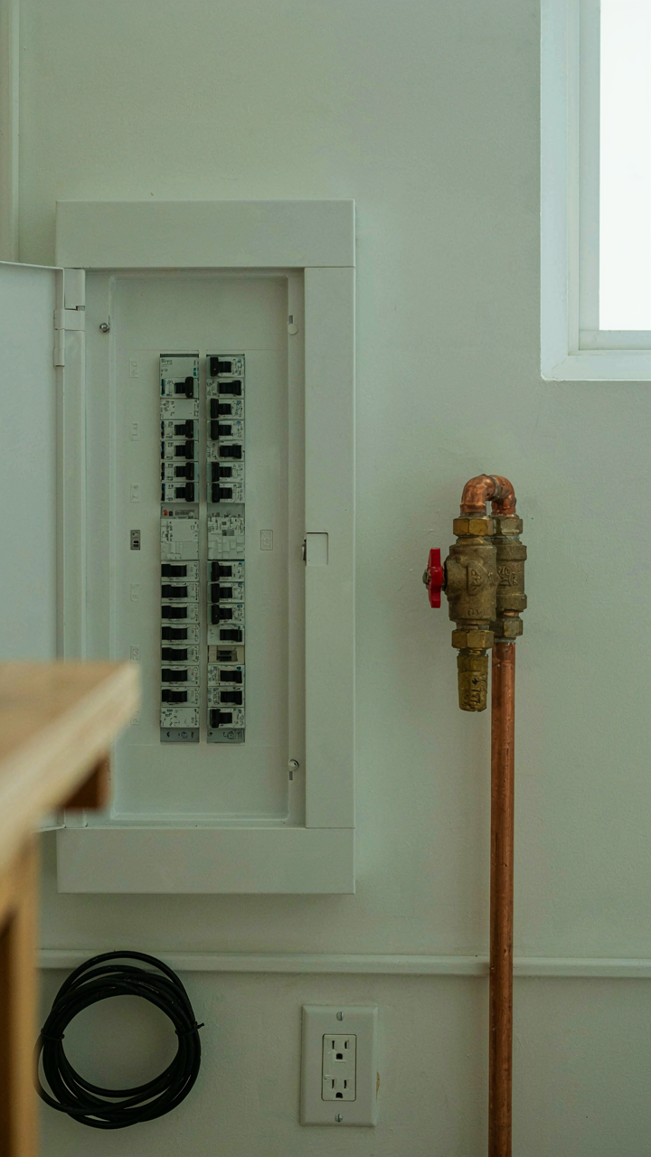 Organized utility panel showing connections to main house and guest house.