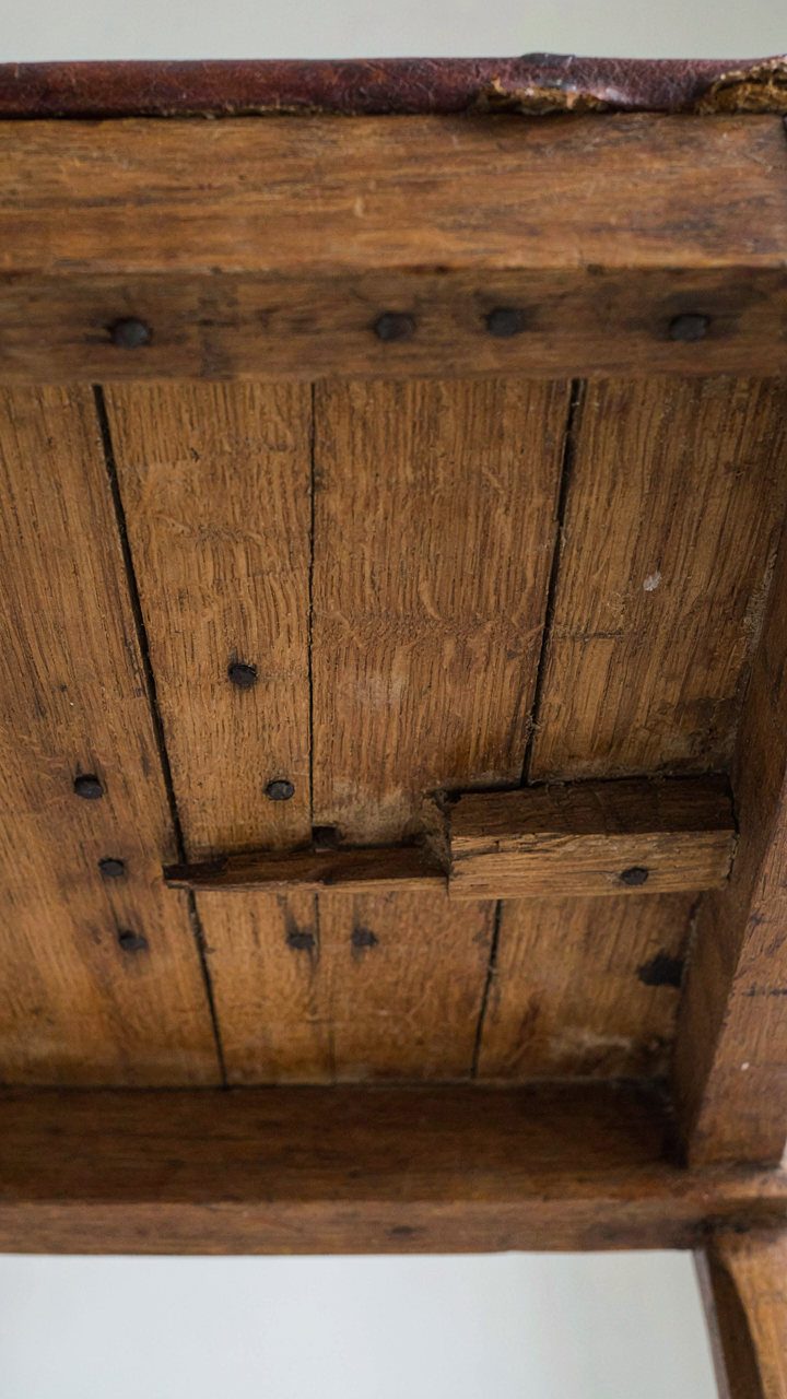 Close-up of an antique chair with hand-planed wood and square nails.