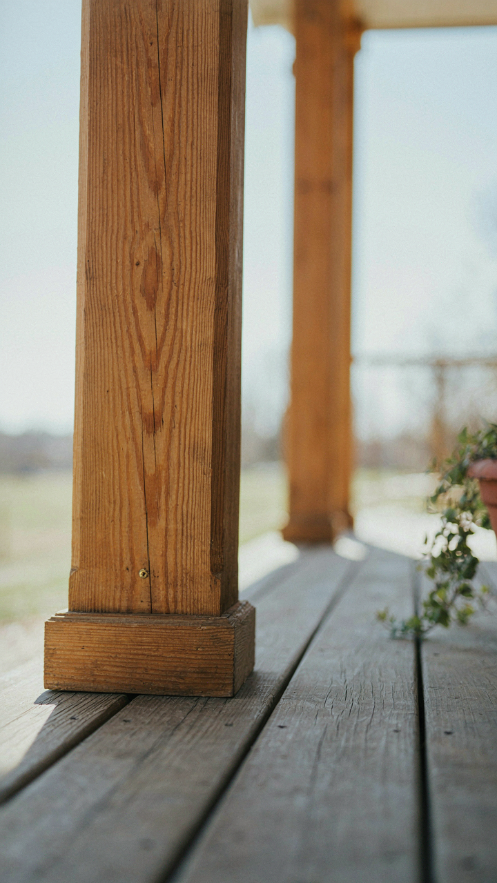 Close-up of a craftsman porch tapered column, showcasing its wood grain and precise joinery.