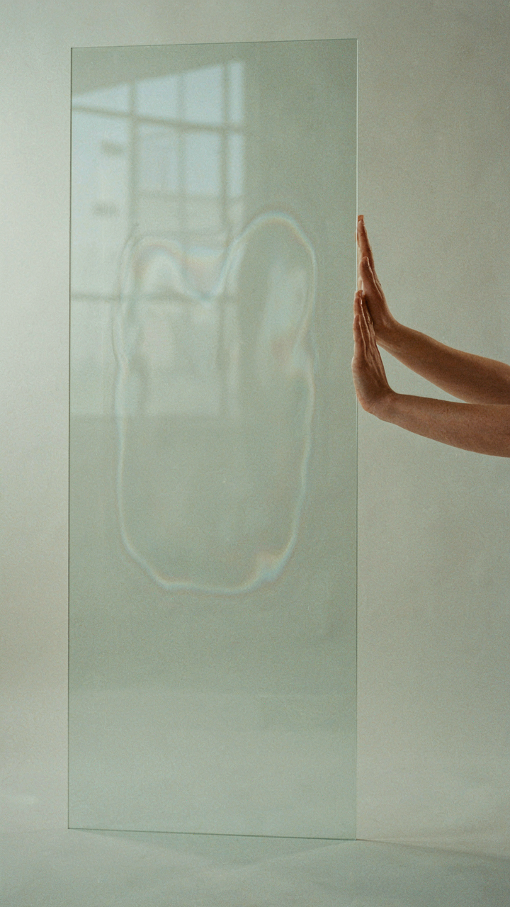 Heat waves are shown passing through a glass pane, demonstrating conduction.