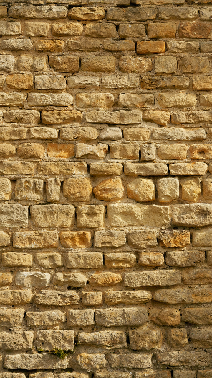 Cross-section of a thick Cotswold cottage stone wall with dry joints.
