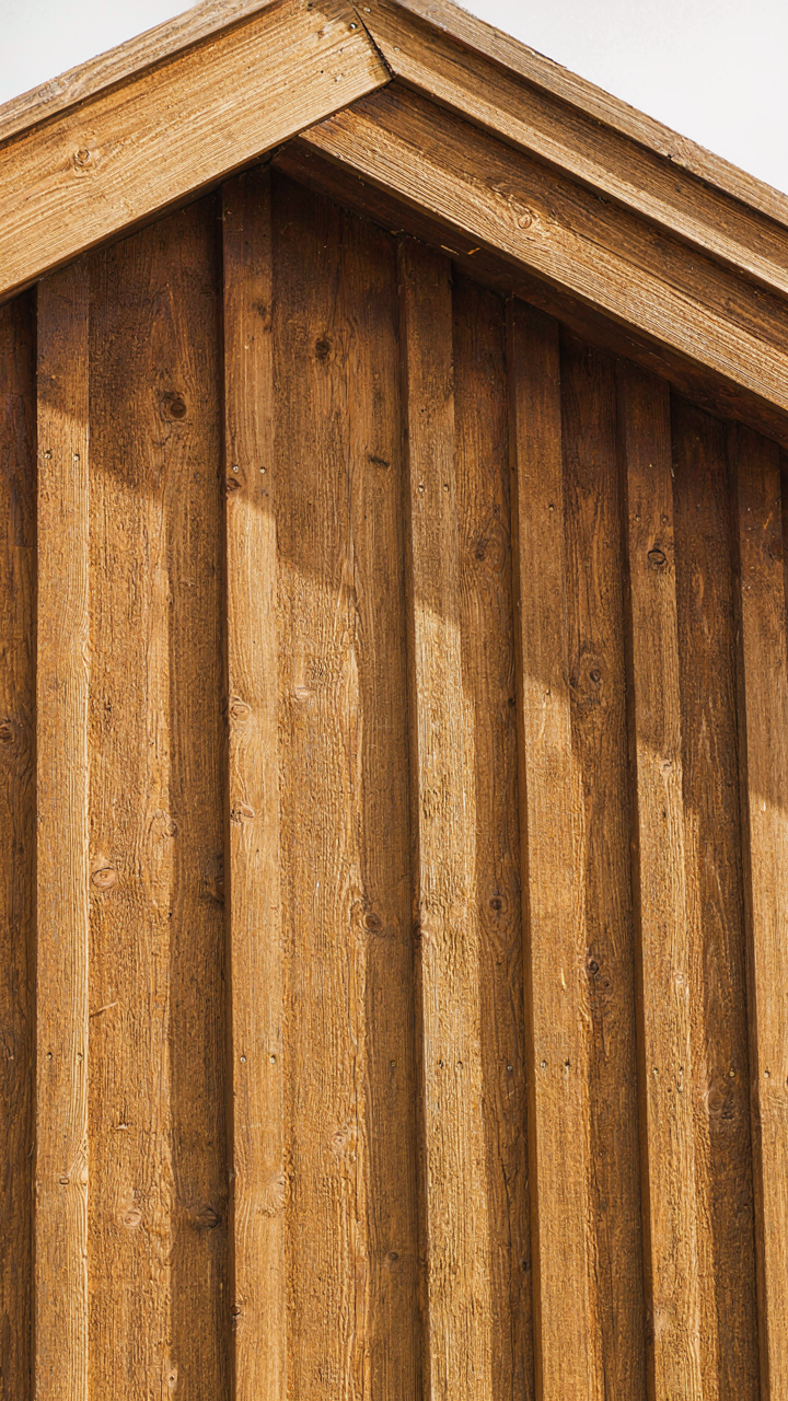 Close up of durable pressure-treated wood siding on a scandinavian guest house.