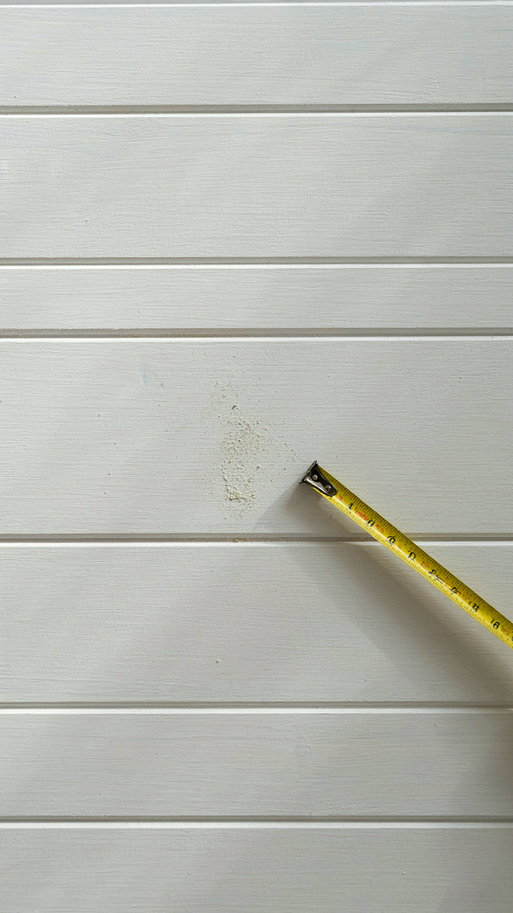 Close up of shiplap boards with uniform, precise gaps and shadow lines.