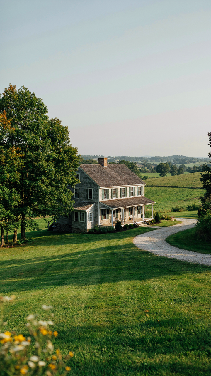 A farmhouse sits on a south-facing slope, oriented to minimize wind, with trees as a windbreak.