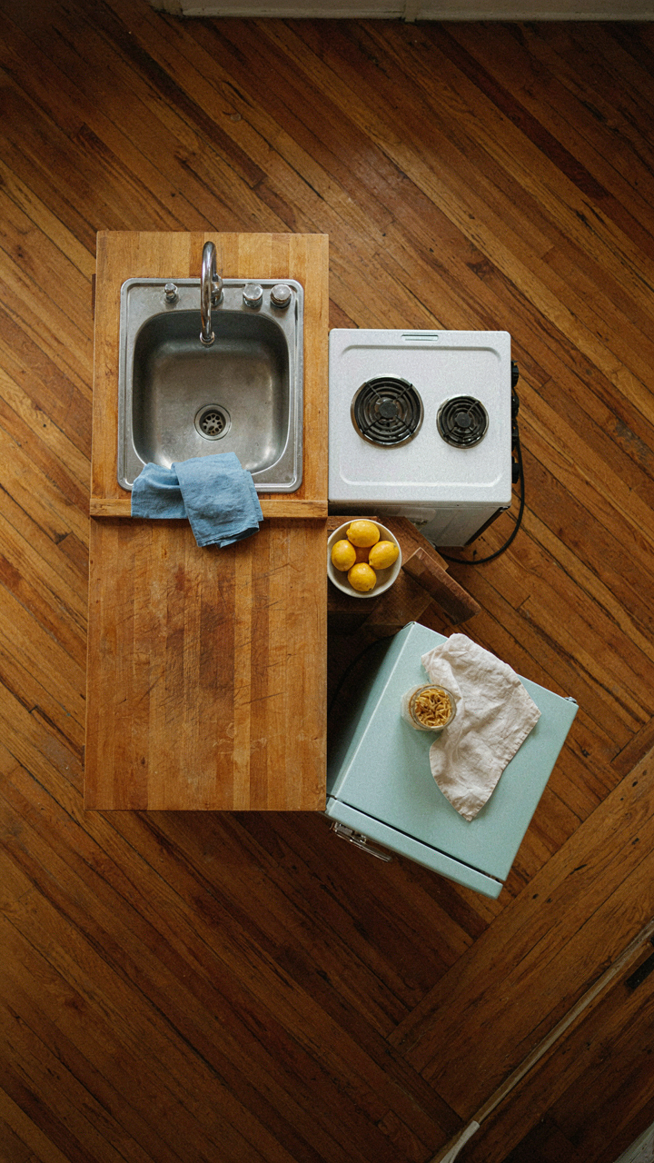 An overhead view of a compact kitchen triangle in a small cabin.