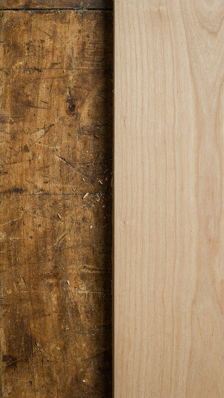A close-up of an old French country table showing deep patina and wear.